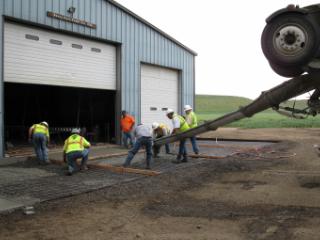 Men pouring concrete.